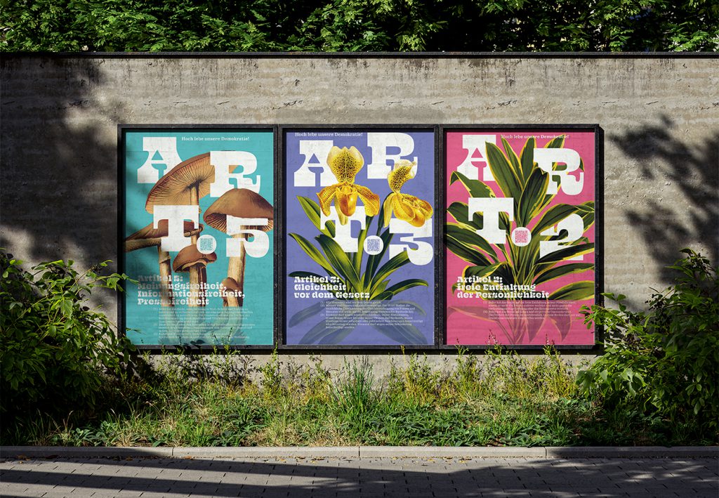 Drei Grundrechte-Poster der Edition D zu Artikel 2, 3 und 5 nebeneinander an einer Wand