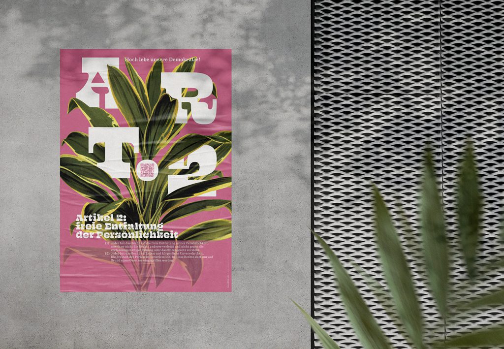 Grundrechte-Poster der Edition D zu Artikel 2 – Freie Entfaltung der Persönlichkeit, pinkes Motiv mit Zimmerpflanze, an einer Betonwand neben einem Metallgitter